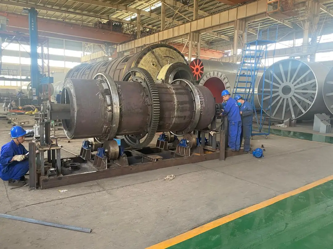 Technicians assembling rotary equipment in an industrial workshop