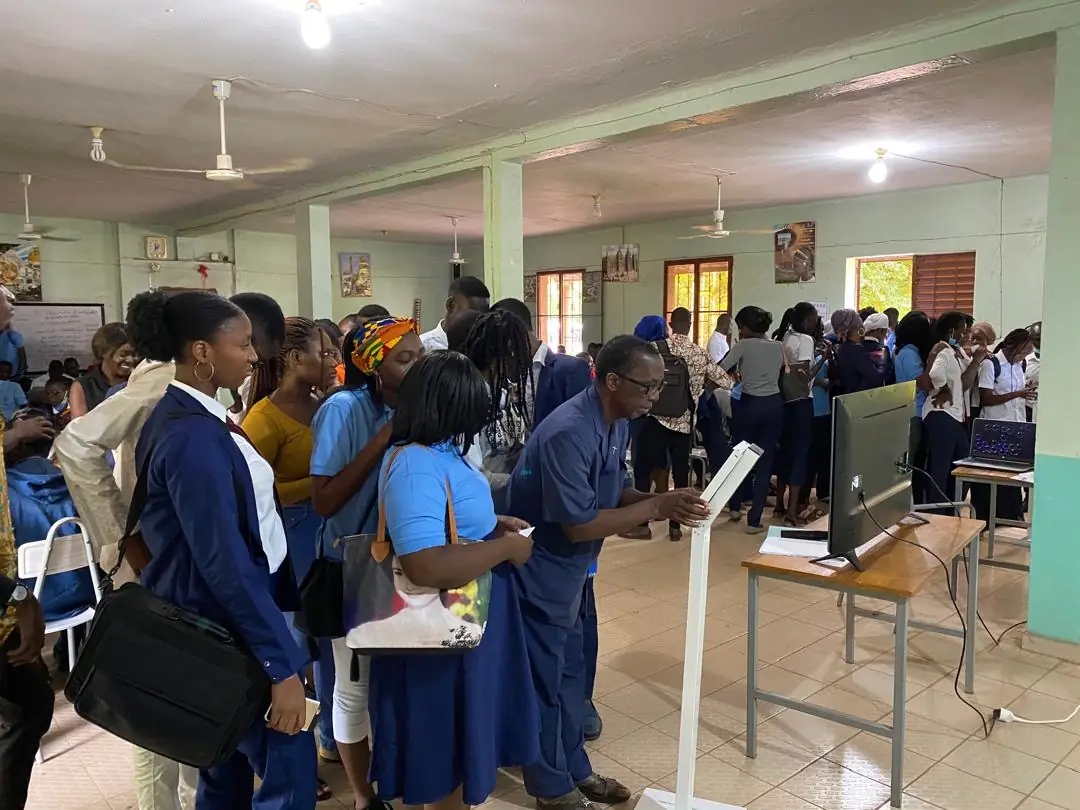 Students gathered in a hall around enrolment stations